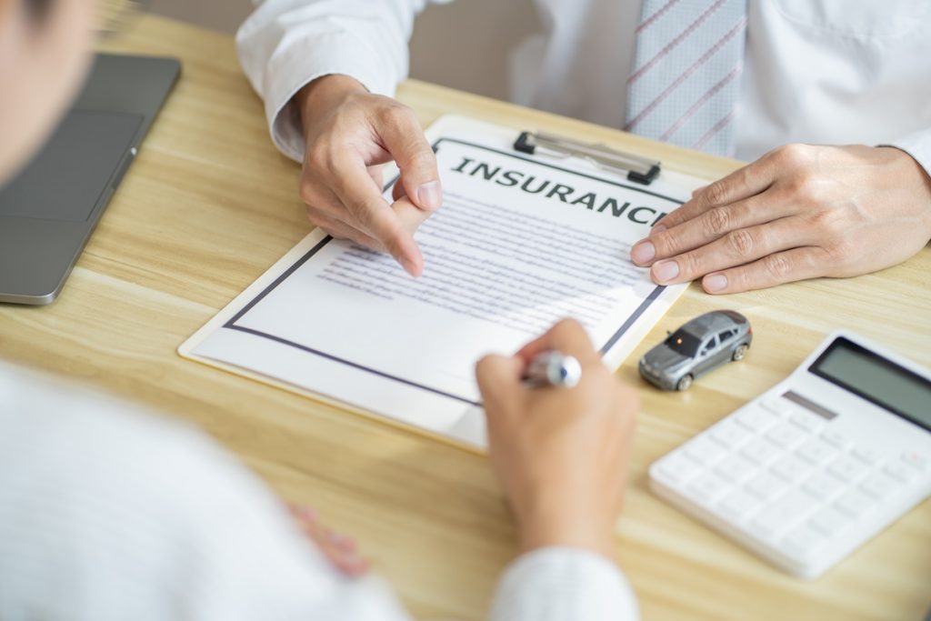 Person Going Over Insurance Terms on a Clipboard