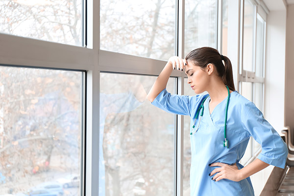 Female doctor holding head in disappointment